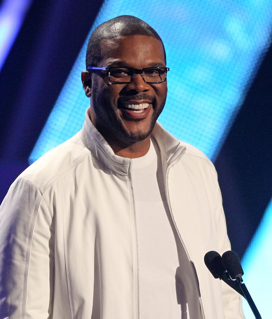 FILE - In this Sunday, July 1, 2012, file photo, Tyler Perry smiles on stage at the BET Awards, in Los Angeles. Essence is known for honoring black women, but during Oscar week, they'll also be lauding the accomplishments of African-American men in film. The magazine is launching its first "Black Men in Hollywood" dinner, an intimate affair that will salute the work of Spike Lee, Lee Daniels, Malcolm Lee and filmmaker Perry, who will host the event. (Photo by Matt Sayles/Invision/AP, File)