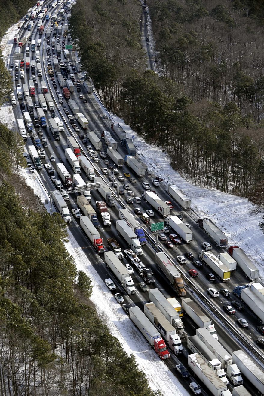 FILE - In this Wednesday, Jan. 29, 2014, file aerial photo, traffic is snarled along the Interstate 285 perimeter, north of the metro area after a winter snowstorm, in Atlanta. With memories of thousands of vehicles gridlocked for hours on icy metro Atlanta highways fresh in their minds, emergency officials and elected leaders in north Georgia were preparing Monday, Feb. 10, 2014, for another round of winter weather. (AP Photo/David Tulis, File)