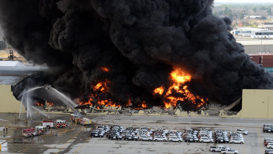 Firefighters battle a rubber fire at Ocean Terminal Warehouse No.3 at the Georgia Ports Authority in Savannah, Ga., on Saturday, Feb. 8, 2014. Burning rubber from the fire at the Port of Savannah sent up a towering column of black smoke that could be seen from miles away. The cause of the fire wasn't immediately known, but all port workers were accounted for and unharmed.(AP Photo/Savannah Morning News, Richard Burkhart)