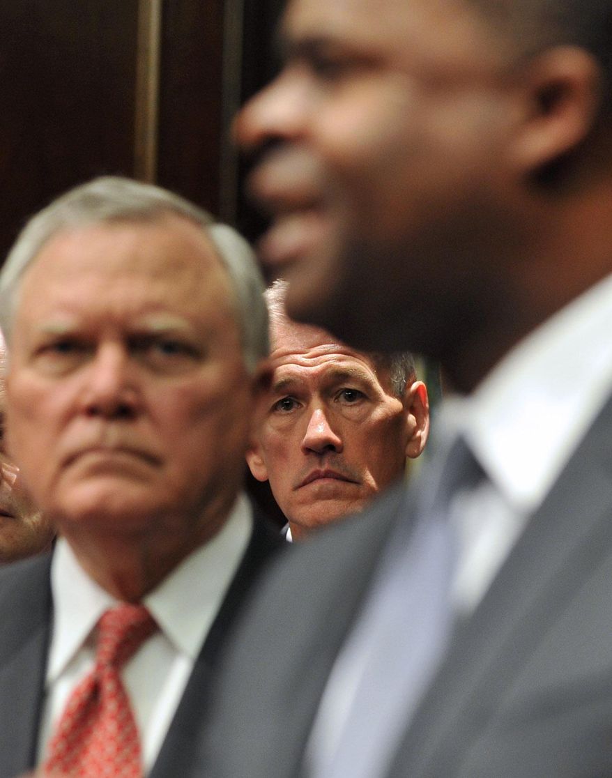 Georgia Emergency Management Director Charley English, center, and Gov. Nathan Deal, left, listen to Atlanta Mayor Kasim Reed speak to reporters during a press conference Monday Feb. 10, 2014. Deal issued a state of emergency Monday morning in advance of winter weather that is forecasted for the area. (AP Photo/Atlanta Journal-Constitution, Brant Sanderlin) MARIETTA DAILY OUT; GWINNETT DAILY POST OUT; LOCAL TV OUT; WXIA-TV OUT; WGCL-TV OUT