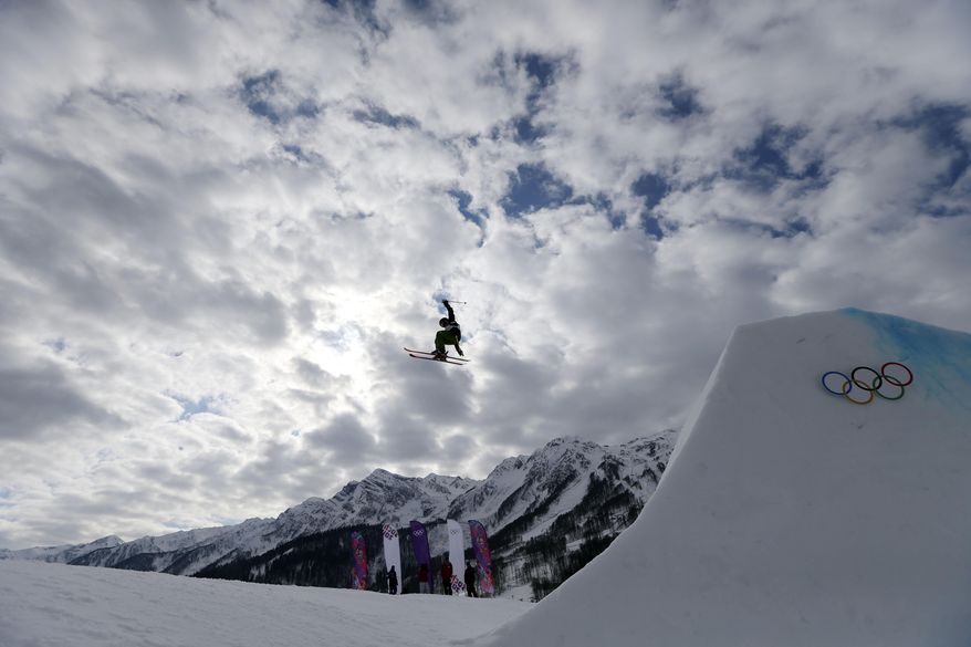 A competitor takes a jump during freestyle skiing slopestyle training at the 2014 Winter Olympics, Monday, Feb. 10, 2014, in Krasnaya Polyana, Russia. (AP Photo/Sergei Grits)