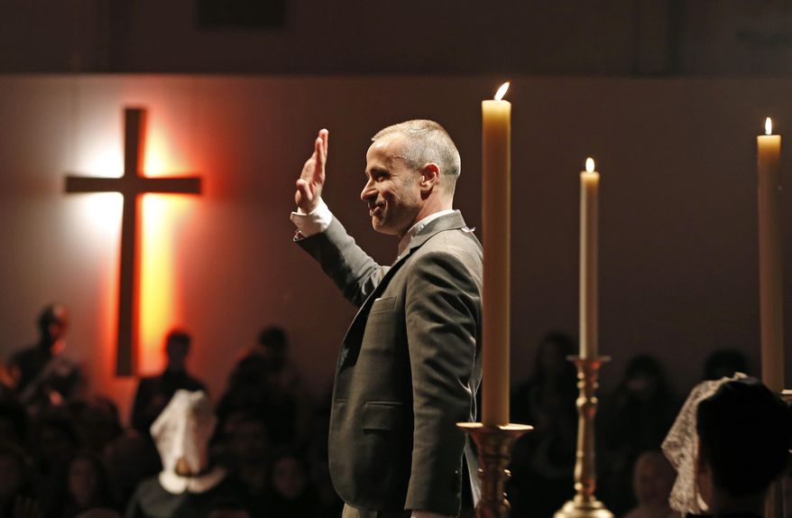 Designer Thom Browne makes an appearance in the church-like atmosphere following the presentation of his Fall 2014 collection in New York, Monday, Feb. 10, 2014.  (AP Photo/Kathy Willens)