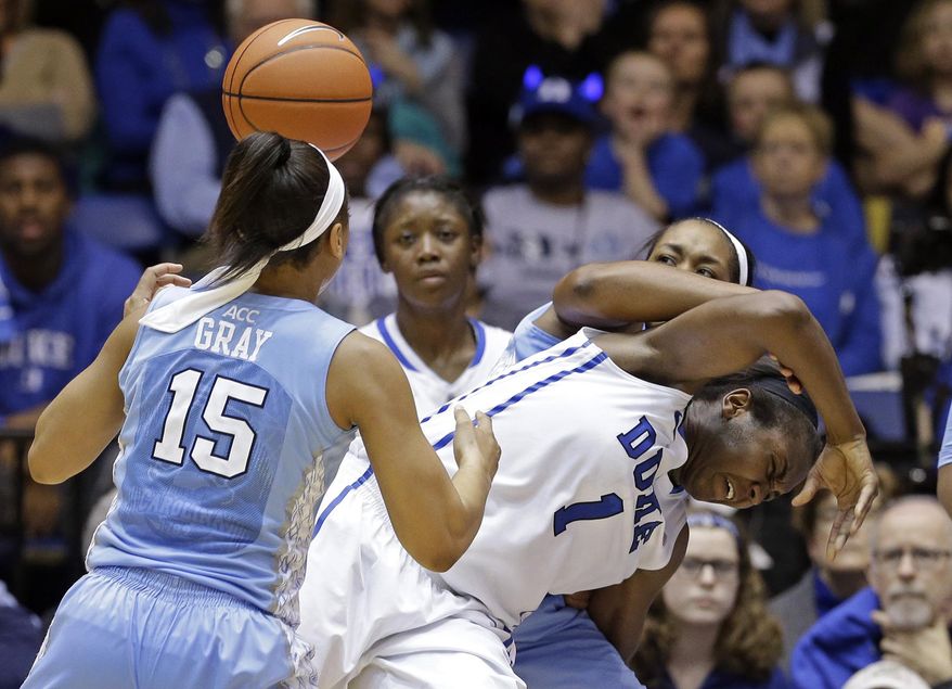 North Carolina's Allisha Gray (15) and Stephanie Mavunga guard Duke's Elizabeth Williams (1) during the second half of an NCAA college basketball game in Durham, N.C., Monday, Feb. 10, 2014. North Carolina won 89-78. (AP Photo/Gerry Broome)
