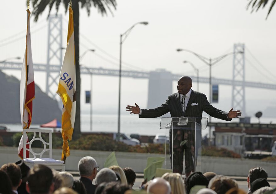 Former San Francisco Mayor and California State Assembly Speaker Willie Brown gestures while speaking during the dedication of the Willie L. Brown, Jr. Bridge at Treasure Island Tuesday, Feb. 11, 2014, in San Francisco. The western span of the San Francisco-Oakland Bay Bridge in the background has been named for the former speaker and mayor. (AP Photo/Eric Risberg)