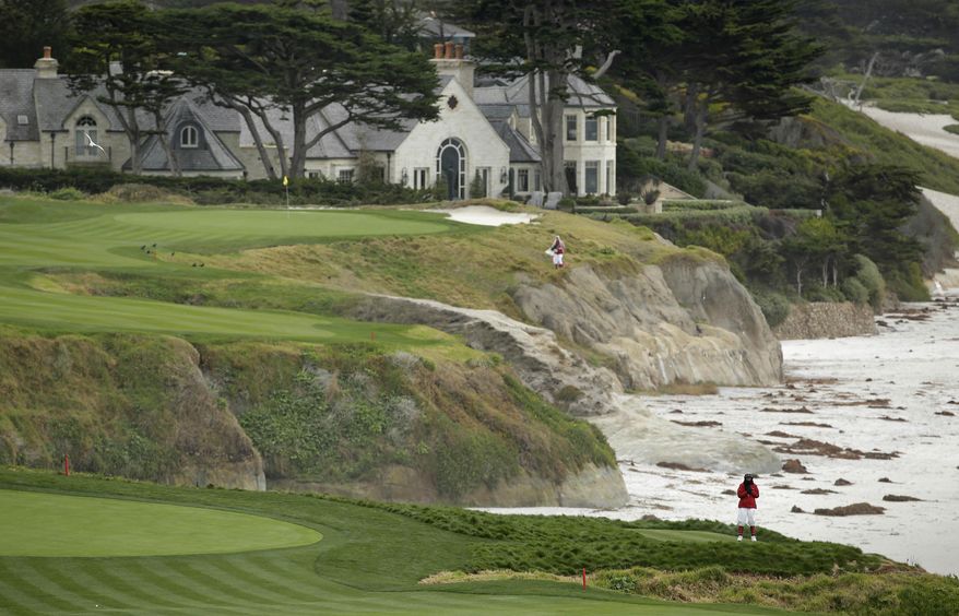 In this photo taken Friday, Feb. 7, 2014, a marshal at lower right stands on an optional 10th tee of the Pebble Beach Golf Links with the 10th green in the background during the second round of the AT&T Pebble Beach Pro-Am golf tournament in Pebble Beach, Calif. The optional 10th tee is to the right of the ninth green. Officials discovered it in old photos and restored it after they rebuilt the ninth green. Pebble Beach wants the USGA to look at it as a possible forward tee in the 2019 U.S. Open. (AP Photo/Eric Risberg)