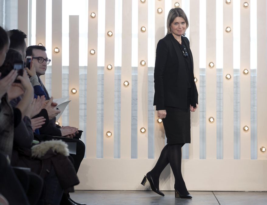 Designer Jenny Packham acknowledges audience applause after her Fall 2014 collection was modeled during Fashion Week in New York, Tuesday, Feb. 11, 2014. (AP Photo/Richard Drew)