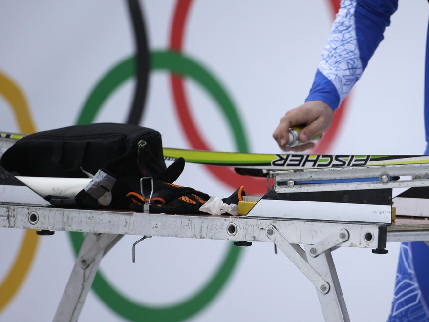 A service technician waxes a ski prior to the cross-country sprint competitions at the 2014 Winter Olympics, Tuesday, Feb. 11, 2014, in Krasnaya Polyana, Russia. (AP Photo/Gregorio Borgia)