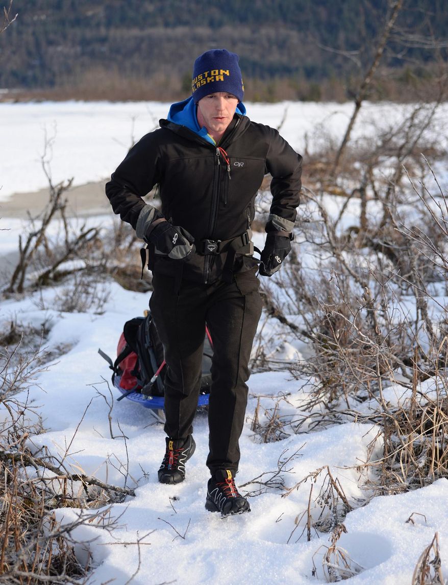 In this photo taken on Feb. 9, 2014, Houston Laws tows his recrafted sled across the snow at Mendenhall Lake near Juneau, Alaska, during a training run for the Susitna 100, a 100-mile ski, bike or run event that starts on Saturday, Feb. 15. It will be the first of four 100-mile races Laws hopes to complete in 2014 to achieve an Alaska ultrarunning "Grand Slam." The Alaska grand slam consists of the Susitna, the White Mountains 100, the Sluice Box 100 and the Resurrection Pass Trail 100. (AP Photo/The Juneau Empire, Klas Stolpe)