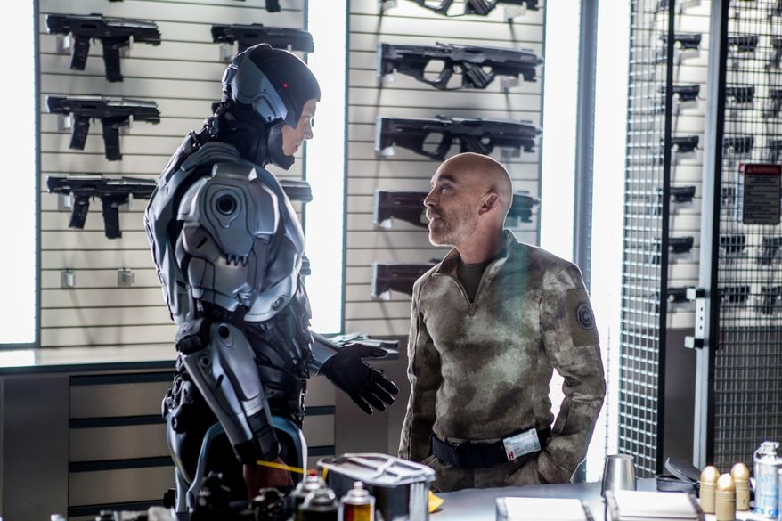 This image released by Columbia Pictures shows Joel Kinnaman, left, and Jackie Earle Haley in a scene from "RoboCop." (AP Photo/Columbia Pictures - Sony, Kerry Hayes)