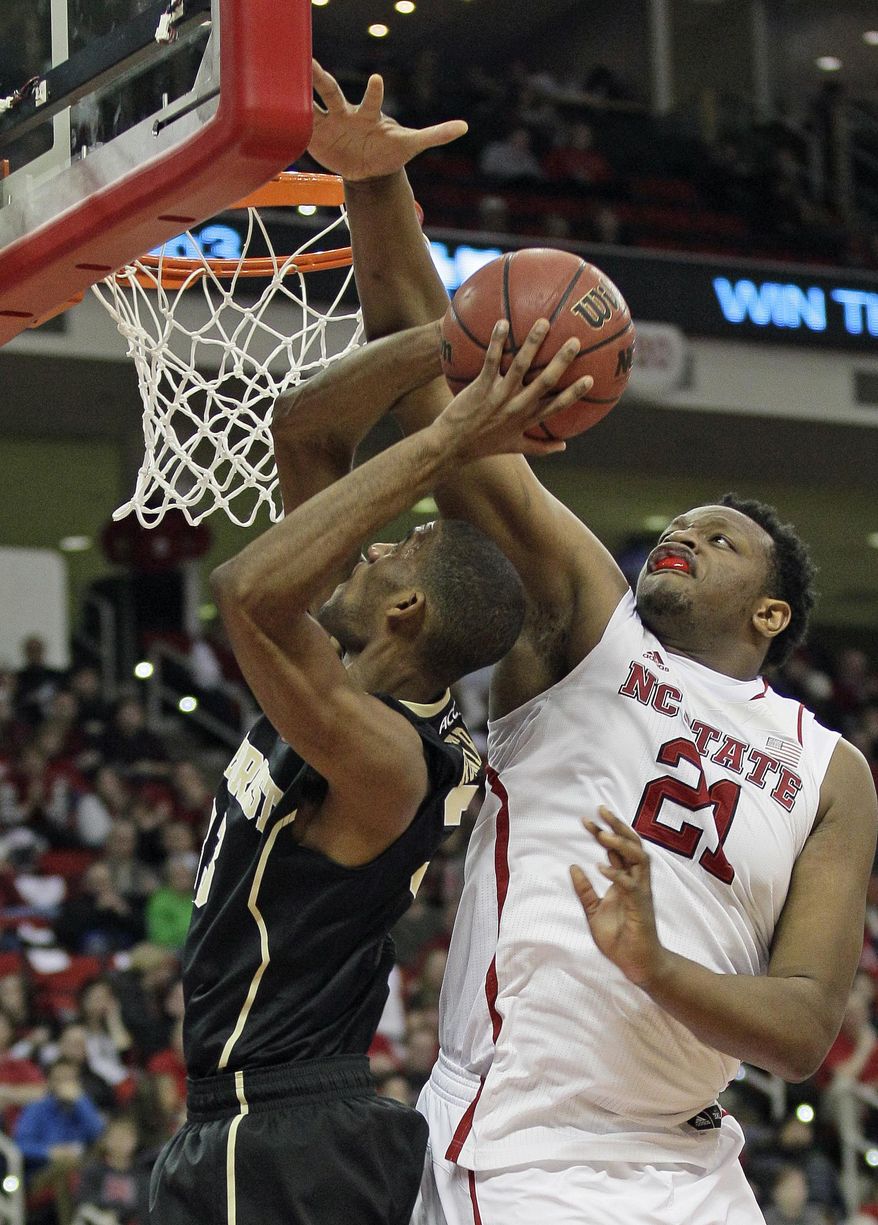 North Carolina State's Beejay Anya (21) blocks Wake Forest's Aaron Rountree III during the second half of an NCAA college basketball game in Raleigh, N.C., Tuesday, Feb. 11, 2014. North Carolina State won 82-67. (AP Photo/Gerry Broome)