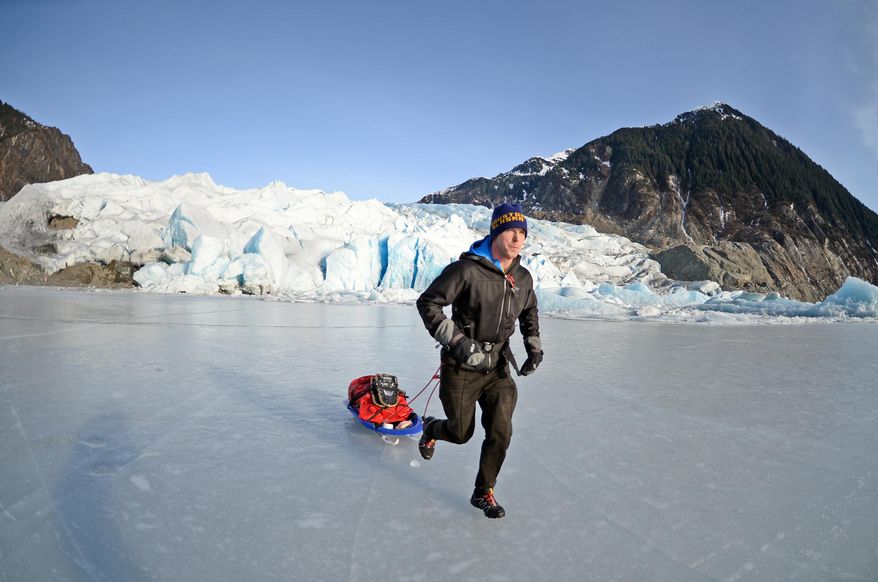 In this photo taken on Feb. 9, 2014, Houston Laws tows his recrafted sled across the ice at Mendenhall Lake near Juneau, Alaska, during a training run for the Susitna 100, a 100-mile ski, bike or run event that starts on Saturday, Feb. 15. It will be the first of four 100-mile races Laws hopes to complete in 2014 to achieve an Alaska ultrarunning "Grand Slam." The Alaska grand slam consists of the Susitna, the White Mountains 100, the Sluice Box 100 and the Resurrection Pass Trail 100. (AP Photo/The Juneau Empire, Klas Stolpe)
