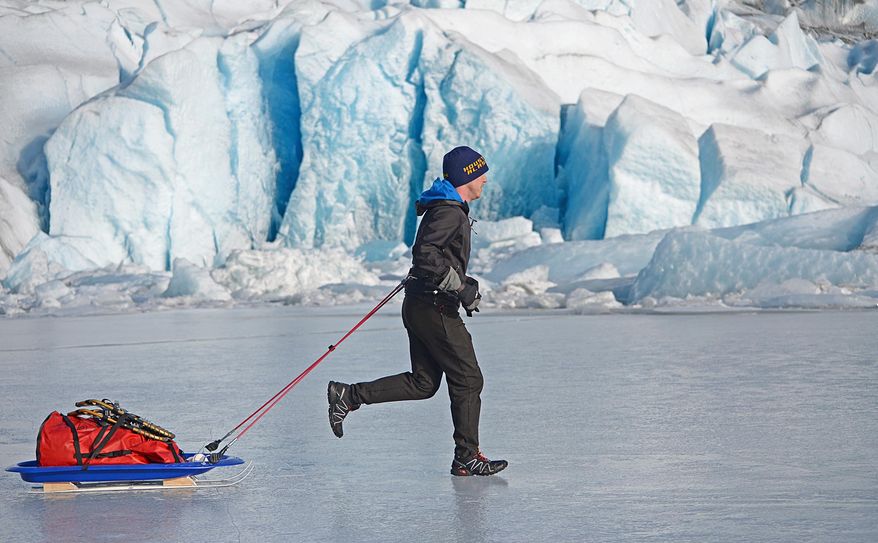In this photo taken on Feb. 9, 2014, Houston Laws tows his recrafted sled across the ice at Mendenhall Lake near Juneau, Alaska, during a training run for the Susitna 100, a 100-mile ski, bike or run event that starts on Saturday, Feb. 15. It will be the first of four 100-mile races Laws hopes to complete in 2014 to achieve an Alaska ultrarunning "Grand Slam." The Alaska grand slam consists of the Susitna, the White Mountains 100, the Sluice Box 100 and the Resurrection Pass Trail 100. (AP Photo/The Juneau Empire, Klas Stolpe)