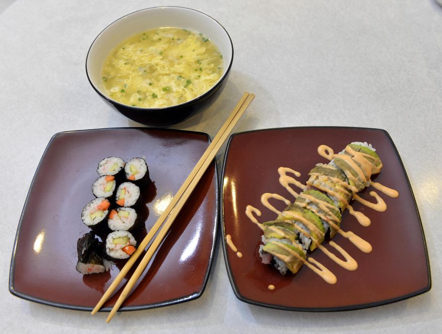 ADVANCE FOR USE MONDAY, FEB. 17 AND THEREAFTER - In this photo taken on Feb. 1, 2014, young cook Isaiah Hall created two varieties of sushi and egg drop soup for his family's lunch in St. Cloud, Minn. Isaiah has cooked for eight years. He writes the blog and has a YouTube channel featuring his cooking videos. (AP Photo/St. Cloud Times, Kimm Anderson) NO SALES