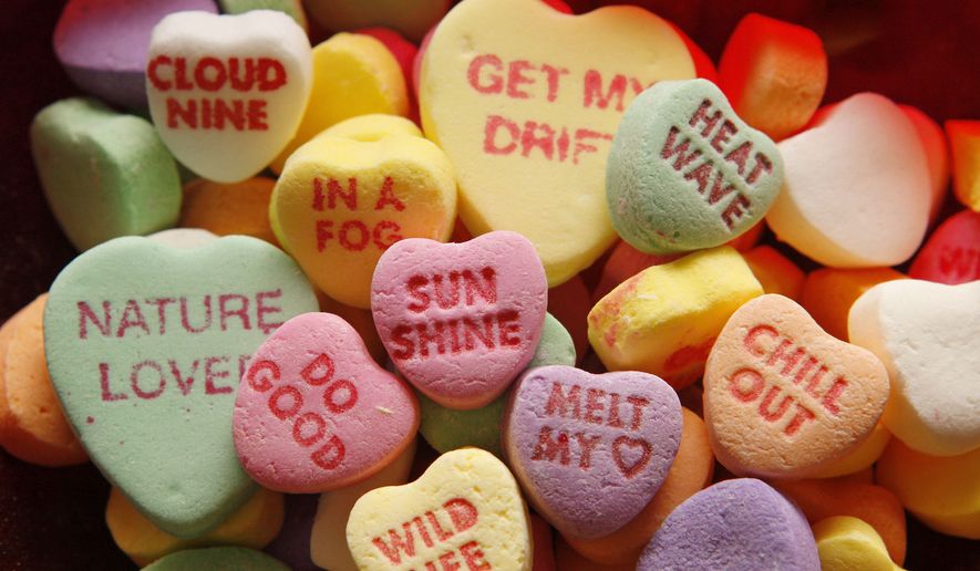 **FILE** This Jan. 9, 2008 file photo provided by NECCO shows sayings imprinted on traditional Valentine's Day heart candies at the NECCO company headquarters in Revere, Mass. (AP Photo/NECCO, Greg M. Cooper, FILE)
