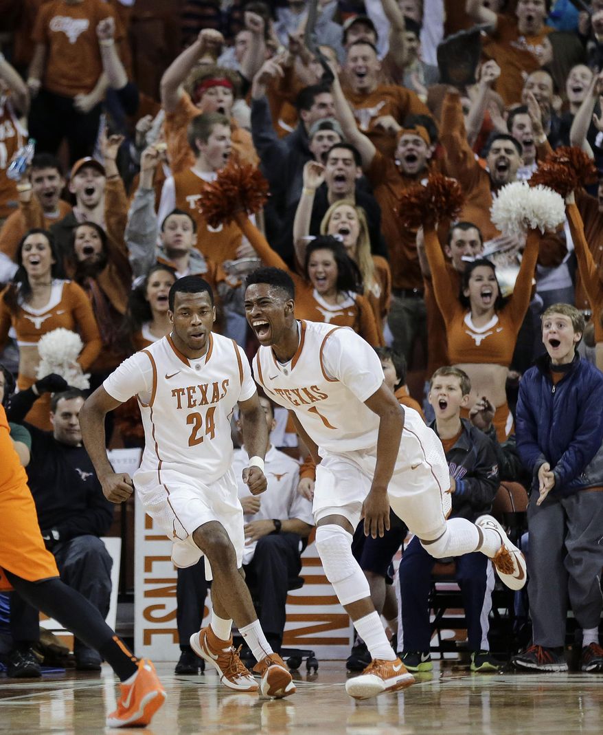 Texas' Martez Walker (24) and Isaiah Taylor (1) celebrate a score by Walker against Oklahoma State during the second half on an NCAA college basketball game, Tuesday, Feb. 11, 2014, in Austin, Texas. Texas won 87-68. (AP Photo/Eric Gay)