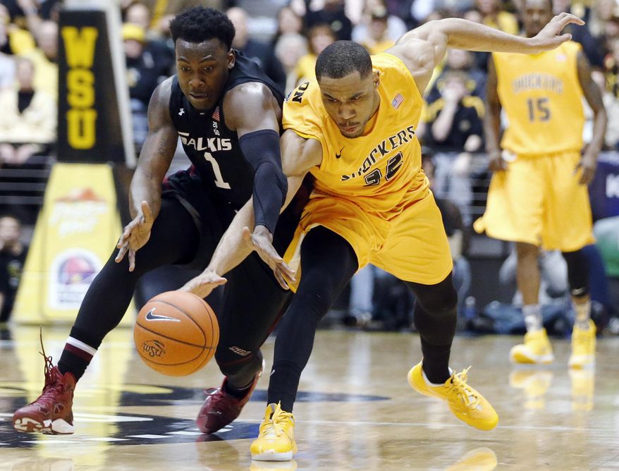 Southern Illinois forward Jalen Pendleton (1 )and Wichita State guard Tekele Cotton (32) scramble for the ball in the final seconds of the first half of an NCAA college basketball game Tuesday, Feb. 11, 2014, in Wichita, Kan. (AP Photo/The Wichita Eagle, Jaime Green) LOCAL TV OUT; MAGS OUT LOCAL RADIO OUT; LOCAL INTERNET OUT