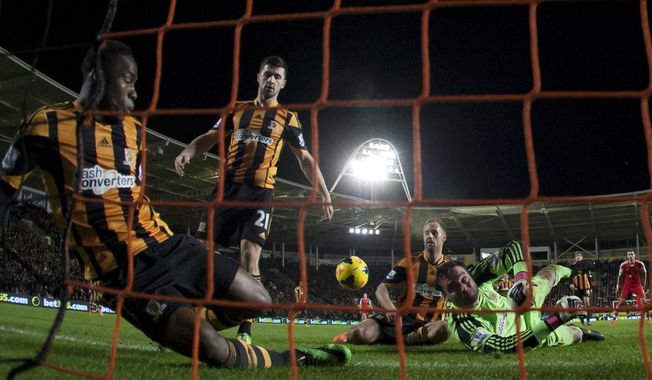 Hull City's goalkeeper Steve Harper, bottom right, dives in vain as Southampton's Jose Fonte, out of frame, scores during their English Premier League soccer match at the KC Stadium, Hull, England, Tuesday Feb. 11, 2014. (AP Photo/Jon Super)