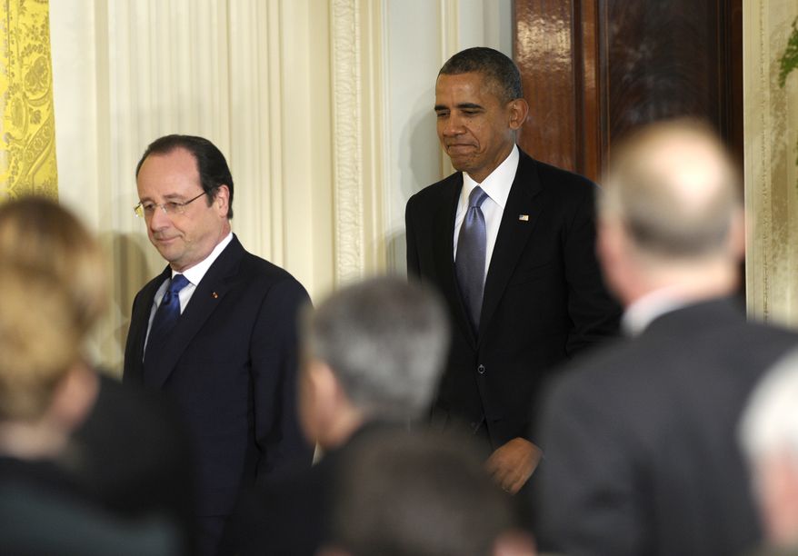President Barack Obama follows French President Francois Hollande as they arrive for a joint news conference, as part of an official state visit, Tuesday, Feb. 11, 2014, in the East Room of the White House in Washington. (AP Photo/ Susan Walsh)