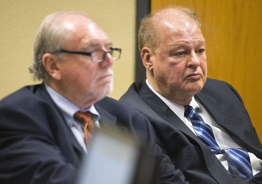 Attorney Michael Kimerer, left, works on behalf of Arizona Attorney General Tom Horne, right, during a hearing on Feb. 10, 2014 in Phoenix, Ariz. A prosecutor says evidence will show that Horne was in constant communication with Kathleen Winn, an aide who was running an independent group backing him in the 2010 election, and she passed along his suggestions about campaign ads attacking his Democratic rival to her campaign consultant. That "coordination" is illegal in Arizona, and Kreutzberg told a judge hearing a civil case brought against Horne and Winn that interviews and telephone, email and other records gathered during an FBI investigation will prove it. (AP Photo/The Arizona Republic, Tom Tingle) MARICOPA COUNTY OUT; MAGS OUT; NO SALES