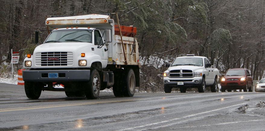 A Fort Payne Public Works truck sands a hill on highway 35 at the top of Lookout Mountain Wednesday Feb. 12, 2014 in Fort Payne Ala. A winter storm warning covered almost the entire northern half of the state, and many schools and businesses were closed or opened late. (AP Photo/Hal Yeager)