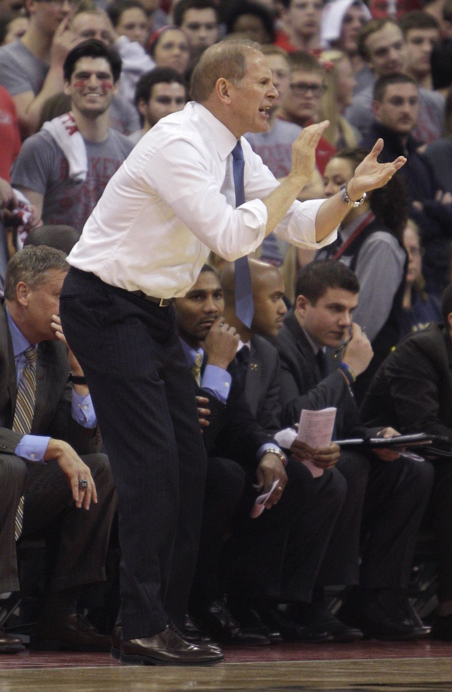Michigan coach John Beilein cheers for his team during the first half of an NCAA college basketball game against Ohio State, Tuesday, Feb. 11, 2014, in Columbus, Ohio. (AP Photo/Jay LaPrete)