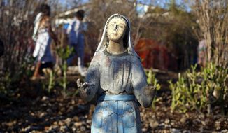 In this Feb. 8, 2014 photo, a weathered statue of the Virgin Mary stands in the yard of Our Lady of Fatima center during a religious gathering organized by the center in the village of Bois-Neuf, Haiti.  The 2010 earthquake in Haiti that killed tens of thousands of people and displaced 1.5 million others was on the minds of many pilgrims, and cited as a chief reason to have faith in God. (AP Photo/Dieu Nalio Chery)