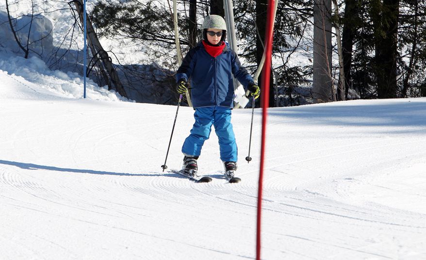 In this photo Thursday Jan. 30, 2014 taken 8-year-old Elliot Phifer navigates turns through the terrain-based learning center at Cranmore Mountain ski area in North Conway, N.H. The terrain-based learning center is a new way to teach new skiers how to ski and not be afraid of the mountain.(AP Photo/Jim Cole)