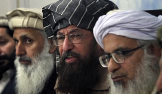 In this Monday, Feb. 3, 2014 photo, negotiators from Pakistani Taliban committee, from left, to right Ibrahim Khan, Maulana Sami-ul-Haq and Maulana Abdul Aziz, listen to a reporter during their press conference in Islamabad, Pakistan. The Pakistani government has recently opened negotiations with domestic militants called the Pakistani Taliban designed to end years of fighting in the northwest that has cost thousands of lives and forced hundreds of thousands of people to flee their homes. (AP Photo/Anjum Naveed)
