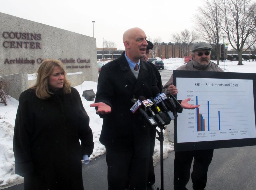 Survivors of clergy sexual abuse Monica Barrett, left, Peter Isely, center, and Michael Sneesby speak to reporters on Wednesday, Feb. 12, 2014, outside the headquarters of the Milwaukee Archdiocese. The archdiocese says it's prepared to set aside $4 million in its bankruptcy reorganization plan to compensate victims of clergy sexual abuse, an amount survivors called insulting. (AP Photo/Dinesh Ramde)