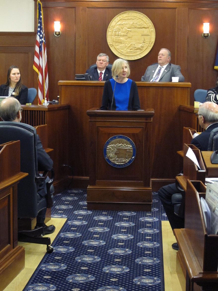 Dana Fabe, the chief justice of the Alaska Supreme Court, delivers the State of the Judiciary address to a joint session of the Alaska Legislature on Wednesday, Feb. 12, 2014, in Juneau, Alaska. Shown behind her as Senate President Charlie Huggins, left, and House Speaker Mike Chenault, right. (AP Photo/Becky Bohrer)