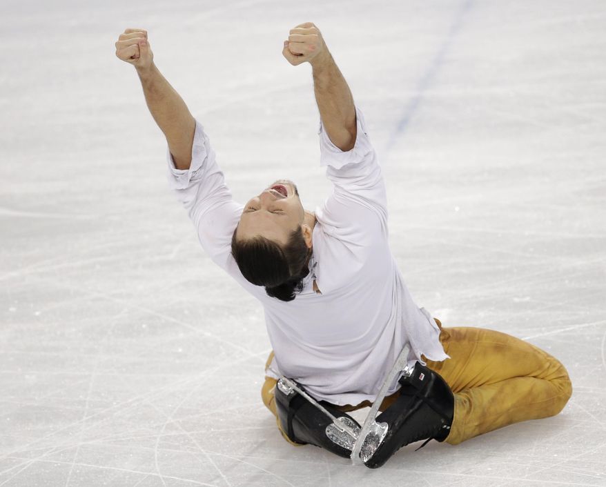 Fedor Klimov reacts after he and Ksenia Stolbova of Russia completed their routine in the pairs free skate figure skating competition at the Iceberg Skating Palace during the 2014 Winter Olympics, Wednesday, Feb. 12, 2014, in Sochi, Russia. (AP Photo/Bernat Armangue)