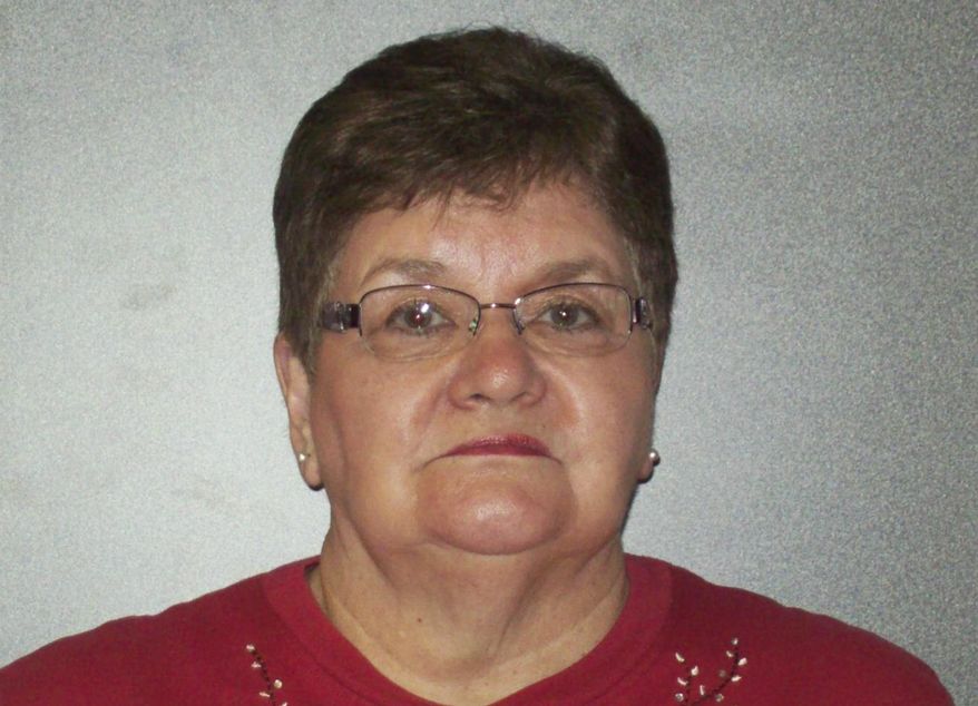This Feb. 4, 2014 photo provided by the Richland County Jail in Wahpeton, N.D., shows Catherine Muehler, 72, who is charged with felony misapplication of entrusted property while operating a state Department of Transportation Motor Vehicle office in Wahpeton. Muehler is the wife of former Richland County Sheriff Harlan Muehler, who was removed from office by the governor 13 years ago for illegal spending and inappropriate behavior toward women. (AP Photo/Courtesy of the Richland County Jail)