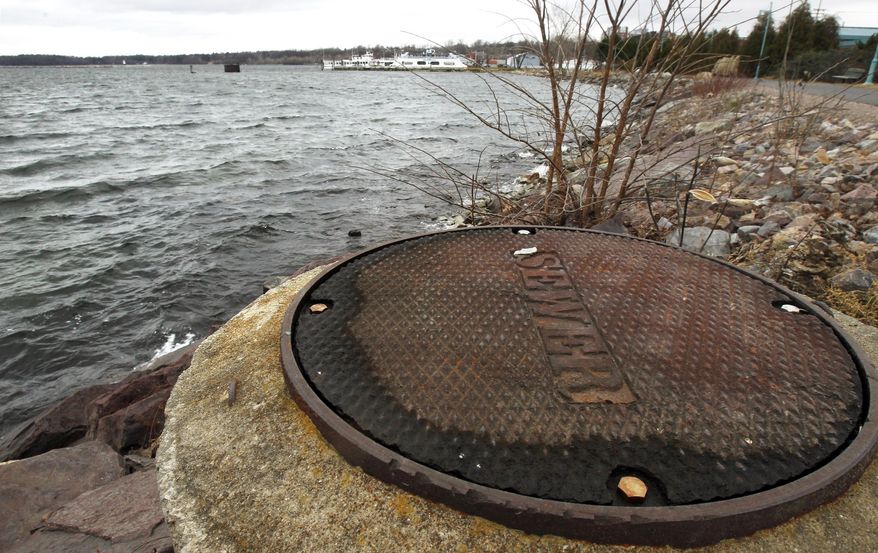 FILE - In this Dec. 5, 2012 file photo, a sewer cover is seen along the shore of Lake Champlain in Burlington, Vt. In a hearing Wednesday, Feb. 12, 2014, Vermont Environmental Conservation Commissioner David Mears outlined a proposal where the state would enhance water quality rules to limit non-wastewater runoff into Lake Champlain. (AP Photo/Toby Talbot, File)