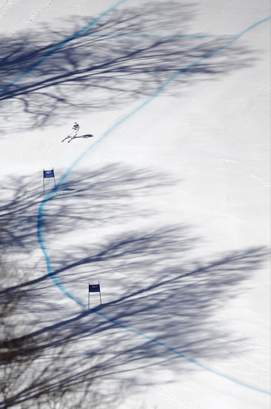 United States' Julia Mancuso makes a turn in the women's downhill at the Sochi 2014 Winter Olympics, Wednesday, Feb. 12, 2014, in Krasnaya Polyana, Russia. (AP Photo/Gero Breloer)