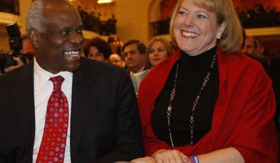 ** FILE ** Supreme Court Justice Clarence Thomas with his wife, Virginia Thomas. (Associated Press)