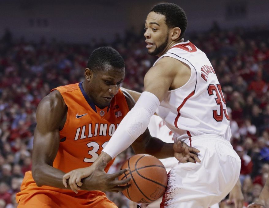 Illinois' Nnanna Egwu (32) drives on Nebraska's Walter Pitchford during the first half of an NCAA college basketball game in Lincoln, Neb., Wednesday, Feb. 12, 2014. (AP Photo/Nati Harnik)