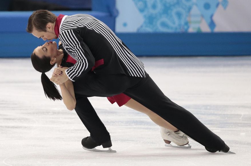Ksenia Stolbova and Fedor Klimov of Russia compete in the pairs free skate figure skating competition at the Iceberg Skating Palace during the 2014 Winter Olympics, Wednesday, Feb. 12, 2014, in Sochi, Russia. (AP Photo/Ivan Sekretarev)
