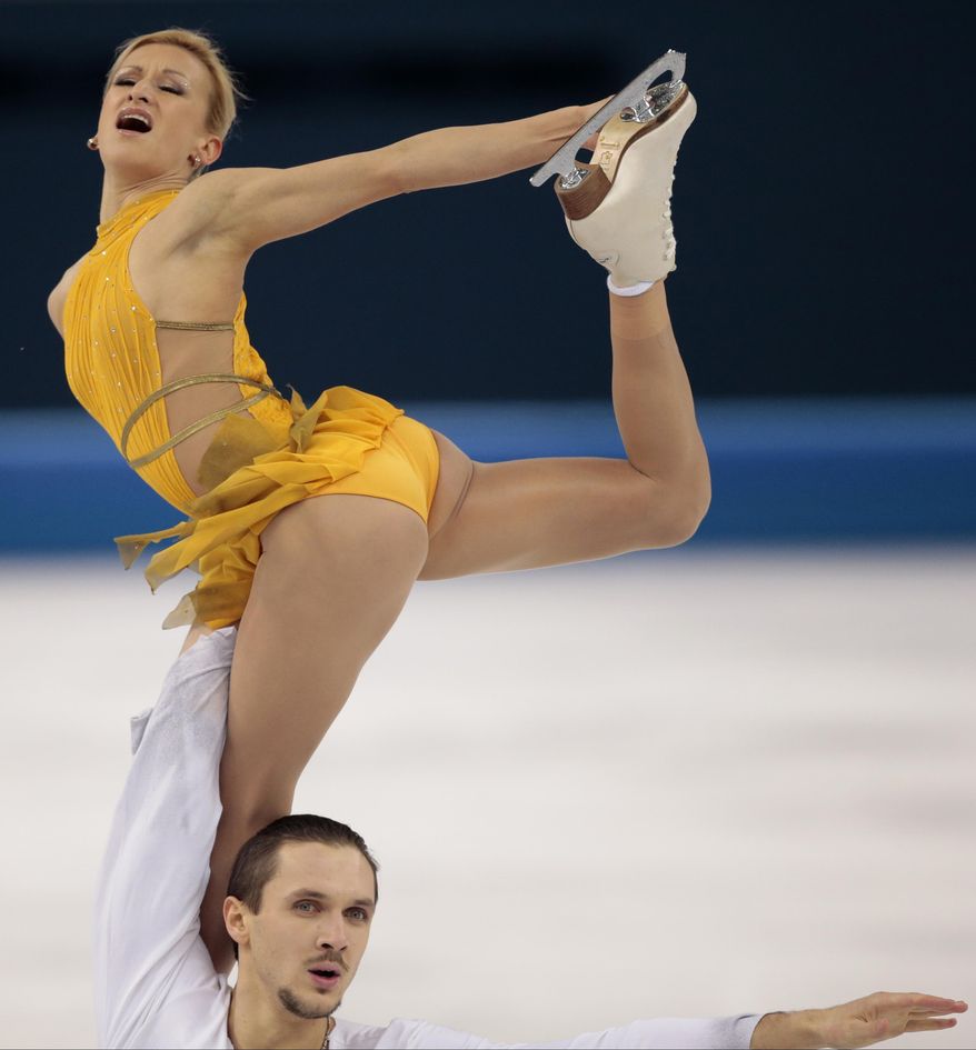 Tatiana Volosozhar and Maxim Trankov of Russia compete in the pairs free skate figure skating competition at the Iceberg Skating Palace during the 2014 Winter Olympics, Wednesday, Feb. 12, 2014, in Sochi, Russia. (AP Photo/Ivan Sekretarev)