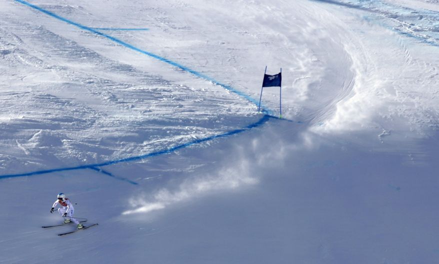 United States' Julia Mancuso makes a turn during the women's downhill at the Sochi 2014 Winter Olympics, Wednesday, Feb. 12, 2014, in Krasnaya Polyana, Russia. (AP Photo/Luca Bruno)