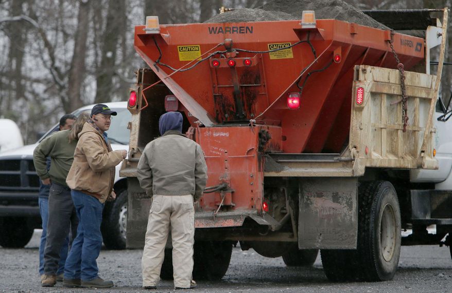 Fort Payne Public Works employees prepare to put sand on icy roads atop Lookout Mountain Wednesday Feb. 12, 2014 in Fort Payne Ala. A winter storm warning covered almost the entire northern half of the state, and many schools and businesses were closed or opened late. (AP Photo/Hal Yeager)