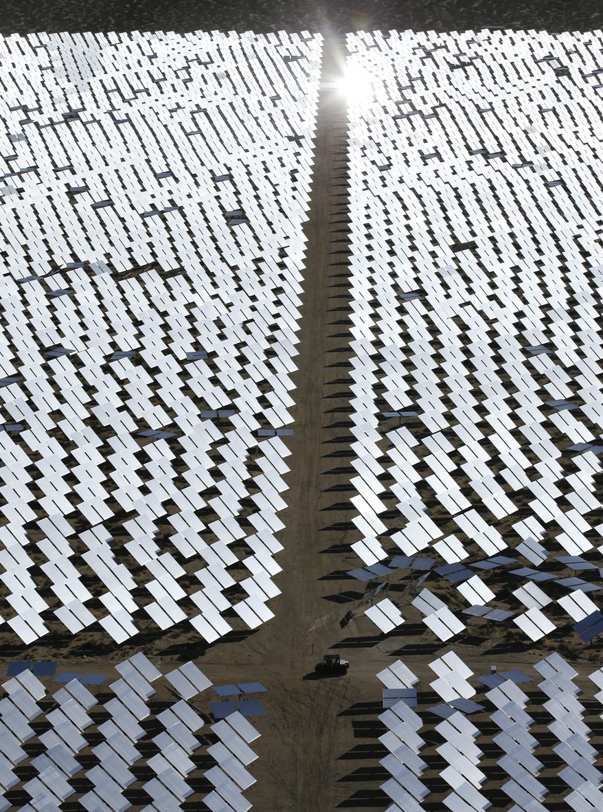 Some of the 300,000 computer-controlled mirrors, each about 7 feet high and 10 feet wide, reflect sunlight to boilers that sit on 459-foot towers. The sun's power is used to heat water in the boilers' tubes and make steam, which in turn drives turbines to create electricity Tuesday, Feb. 11, 2014 in Primm, Nev. The Ivanpah Solar Electric Generating System, sprawling across roughly 5 square miles of federal land near the California-Nevada border, will be opened formally Thursday after years of regulatory and legal tangles. (AP Photo/Chris Carlson)