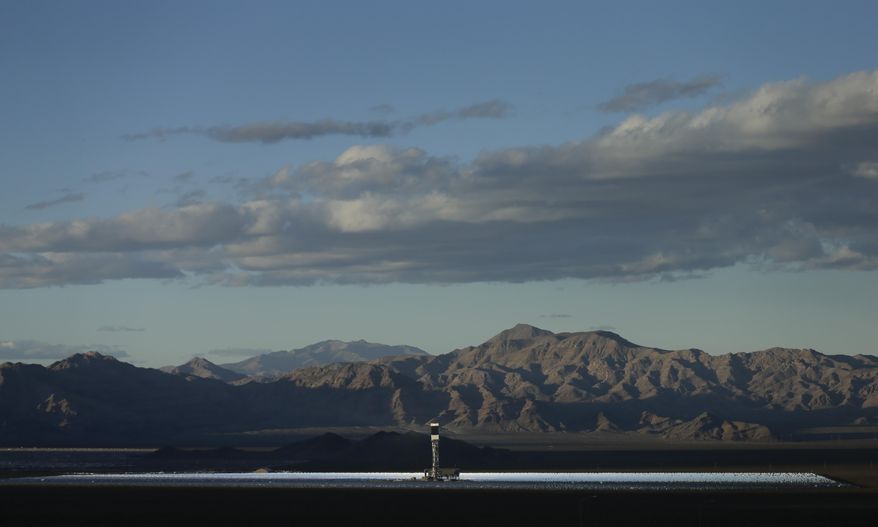 Some of the 300,000 computer-controlled mirrors, each about 7 feet high and 10 feet wide, reflect sunlight to boilers that sit on 459-foot towers. The sun's power is used to heat water in the boilers' tubes and make steam, which in turn drives turbines to create electricity Tuesday, Feb. 11, 2014 in Primm, Nev. The Ivanpah Solar Electric Generating System, sprawling across roughly 5 square miles of federal land near the California-Nevada border, will be opened formally Thursday after years of regulatory and legal tangles. (AP Photo/Chris Carlson)