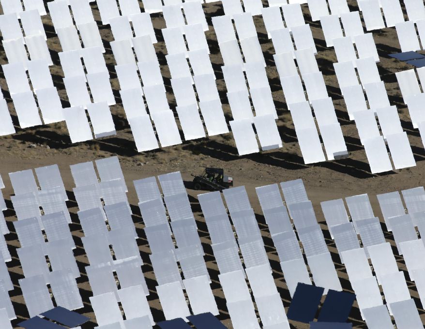 Some of the 300,000 computer-controlled mirrors, each about 7 feet high and 10 feet wide, reflect sunlight to boilers that sit on 459-foot towers. The sun's power is used to heat water in the boilers' tubes and make steam, which in turn drives turbines to create electricity Tuesday, Feb. 11, 2014 in Primm, Nev. The Ivanpah Solar Electric Generating System, sprawling across roughly 5 square miles of federal land near the California-Nevada border, will be opened formally Thursday after years of regulatory and legal tangles. (AP Photo/Chris Carlson)