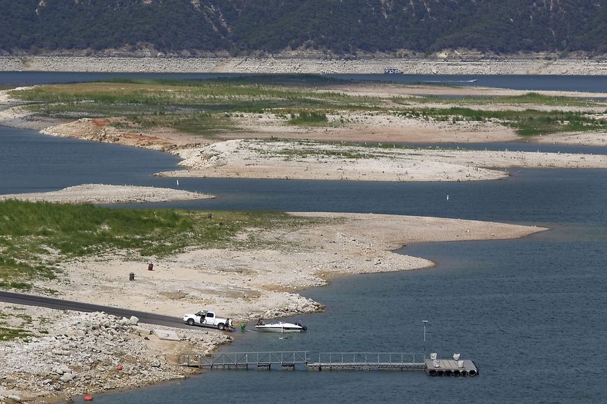FILE - In this Aug. 2, 2011 file photo, Lake Travis levels approach record lows as the heat and record drought are taking its toll on the Highland Lakes, near Austin, Texas. The impacts of record-breaking heat and years of low or no rainfall can be felt years after the dry spell passes, and Texas is now struggling with some of the worst impacts of a historic one-year drought that crippled the state’s lakes, agriculture and water supplies. More than 50 percent of Texas remains in drought despite more consistent rainfall in the past two years, climatologists said. (AP Photo/Austin American Statesman, Ralph Barrera, File) AUSTIN CHRONICLE OUT, COMMUNITY IMPACT OUT, MAGS OUT; NO SALES; INTERNET AND TV MUST CREDIT PHOTOGRAPHER AND STATESMAN.COM