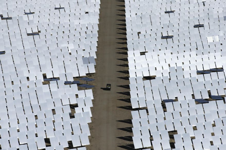 Some of the 300,000 computer-controlled mirrors, each about 7 feet high and 10 feet wide, reflect sunlight to boilers that sit on 459-foot towers. The sun's power is used to heat water in the boilers' tubes and make steam, which in turn drives turbines to create electricity Tuesday, Feb. 11, 2014 in Primm, Nev. The Ivanpah Solar Electric Generating System, sprawling across roughly 5 square miles of federal land near the California-Nevada border, will be opened formally Thursday after years of regulatory and legal tangles. (AP Photo/Chris Carlson)