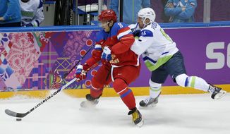 Russia forward Alexander Ovechkin, left, keeps the puck from Sovenia defenseman Matic Podlipnik in the first period of a men&#x27;s ice hockey game at the 2014 Winter Olympics, Thursday, Feb. 13, 2014, in Sochi, Russia. (AP Photo/Mark Humphrey)
