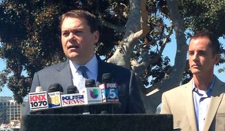 Carl DeMaio, left, a former city councilman who narrowly lost a bid for San Diego mayor last year, announces he won&#39;t seek the job again in a Nov. 19 special election to replace the disgraced Bob Filner in San Diego Calif., on Tuesday, Sept. 3, 2013. At his side in San Diego&#39;s Spanish Landing Park is partner Jonathan Hale. (AP Photo/ Elliot Spagat)