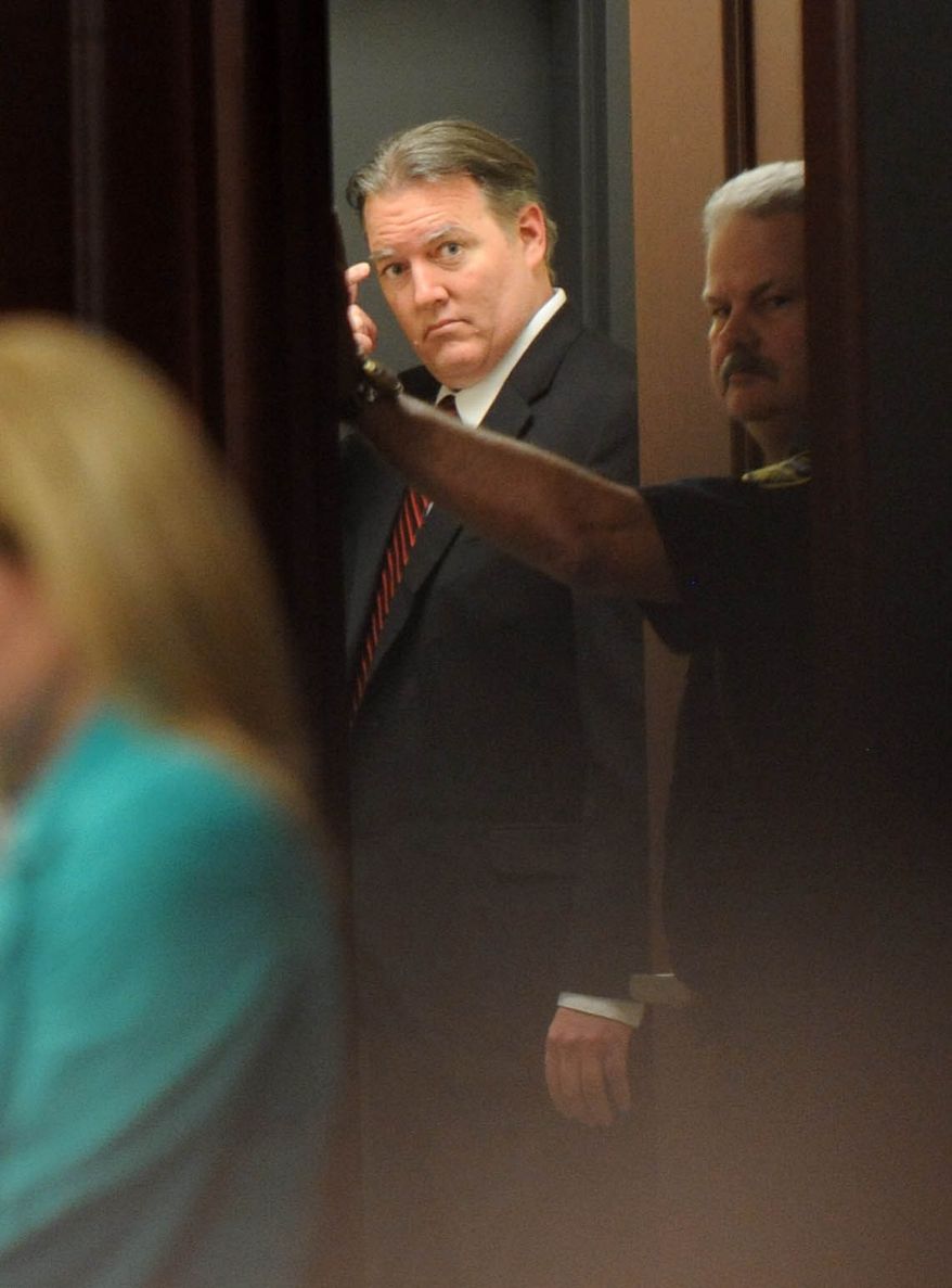 Michael Dunn leaves the courtroom after the verdict is read in Jacksonville, Fla. Saturday, Feb. 15, 2014. Dunn was convicted of attempted murder in the shooting death of a teenager during an argument over loud music, but jurors could not agree on the most serious charge of first-degree murder. (The Florida Times-Union, Bob Mack, Pool)