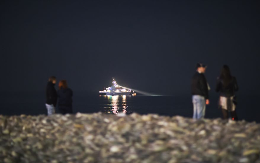 A Russian military vessel patrols the waterfront along the Black Sea, Saturday, Feb. 15, 2014, in central Sochi, Russia, home of the 2014 Winter Olympics. (AP Photo/David Goldman)
