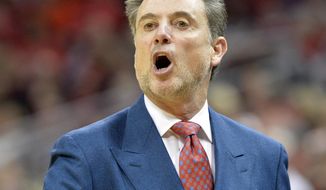 Louisville coach Rick Pitino shouts instructions to his team during the first half of an NCAA college basketball game against Rutgers on Sunday, Feb. 16, 2014, in Louisville, Ky. (AP Photo/Timothy D. Easley)